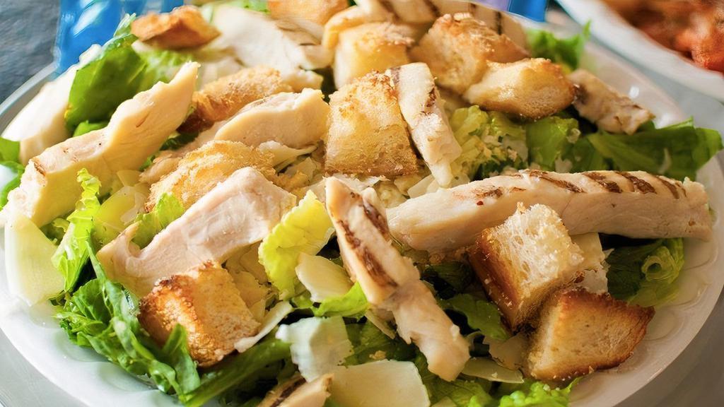 Grilled Chicken Caesar Salad · Chicken breast strips, Romaine lettuce, Parmesan cheese, and homemade croutons with a creamy caesar dressing.