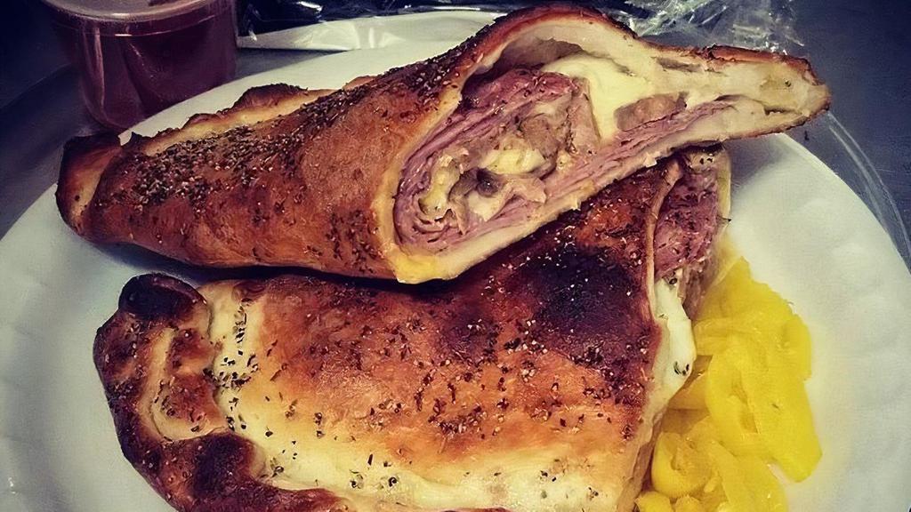 Stromboli · Salami, sausage, ham, cheese, mustard, inside baked and seasoned dough, served with marinara and wax peppers.