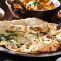 Garlic Basil Naan · Naan bread baked with fresh garlic, basil leaves, herbs and mild spices.