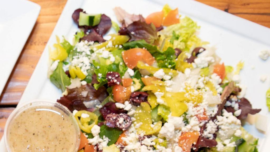 Greek Salad · Lettuce, organic mix green, black olives, tomatoes, cucumbers, onions, pepperoncini, feta cheese, oregano dressing.