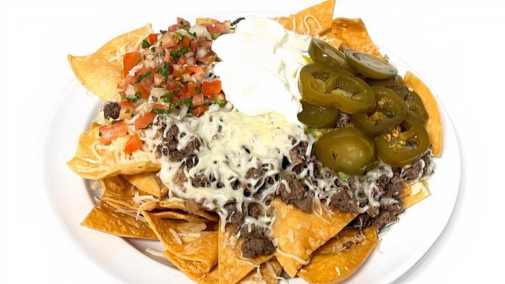 Super Nachos · Meat, tortilla chips, refried beans, jack cheese or nacho cheese, pico de gallo. Sour cream and jalapenos