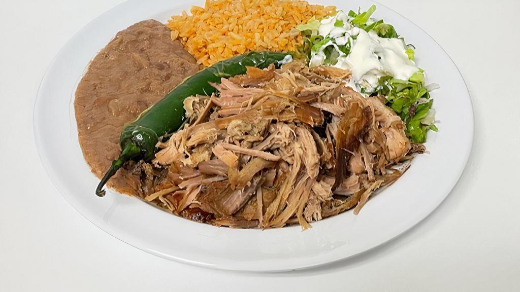 Carnitas Plate · Carnitas, grilled serrano peppers, lettuce, sour cream, rice, refried beans, and 4 tortillas