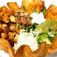 Taco Salad · Crispy flower  tortilla shell, meat, rice, refried beans, onion, cilantro, salsa, lettuce, p...