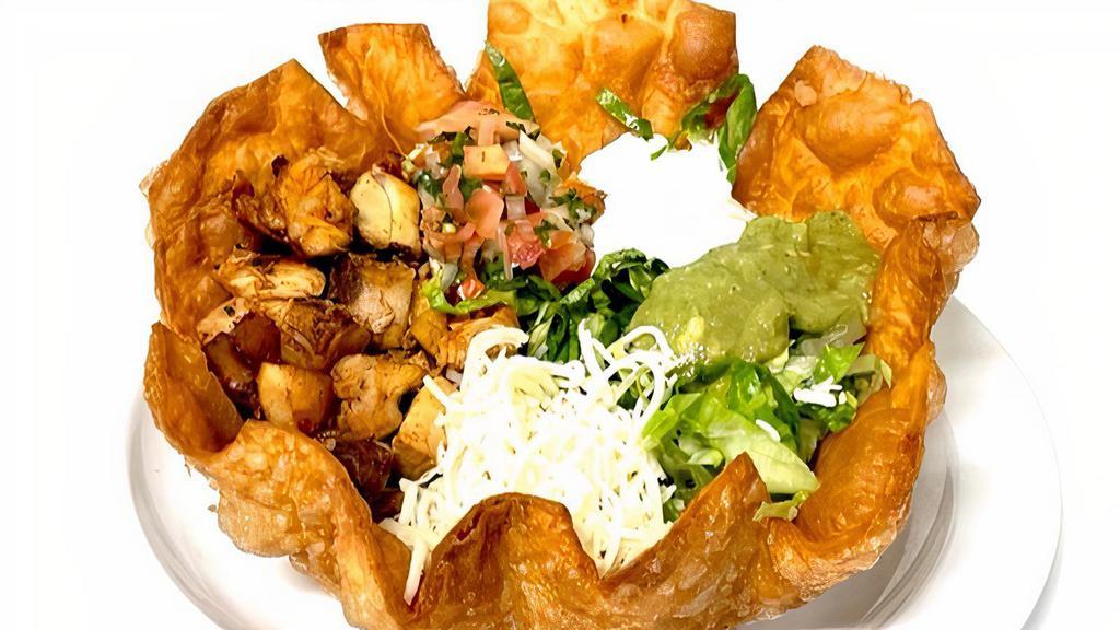Taco Salad · Crispy flower  tortilla shell, meat, rice, refried beans, onion, cilantro, salsa, lettuce, pico de gallo, cheese, sour cream & guacamole