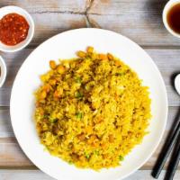 Golden Curry Fried Rice · Curry fried rice w/ soy vegan chicken, carrots & peas