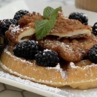 Chicken Waffles · Savory fried chicken and buttermilk waffle topped with fresh blackberries and a side of mapl...