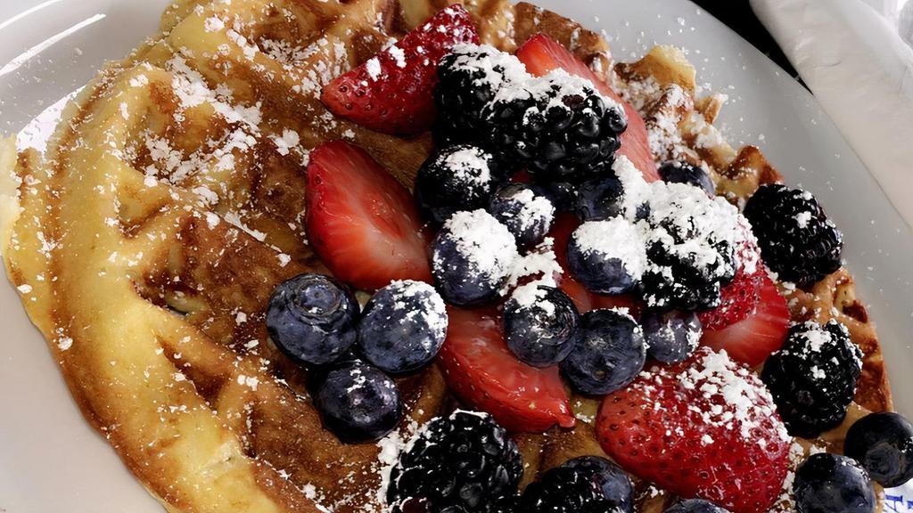 Waffle · Garnished with fresh berries and powdered sugar.
