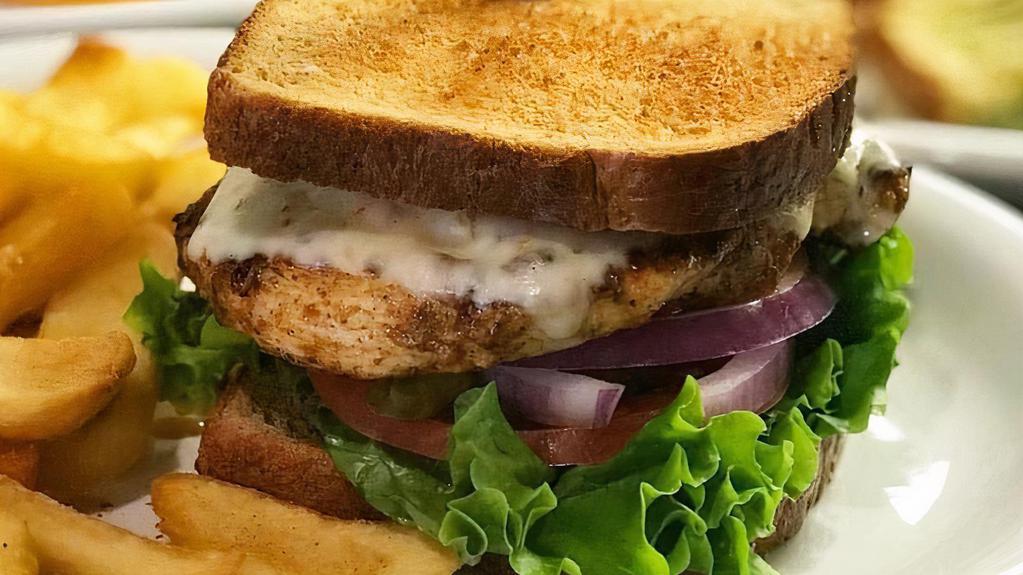 Cajun Chicken · Tender chicken breast marinated in Cajun spices topped with pepper jack cheese lettuce, tomatoes, pickles, onions, avocado and mayo. Served on wheat toast.
