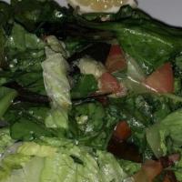 Spot House Salad · Simple yet savory-lettuce, tomatoes and cucumbers tossed with lemon juice and olive oil.