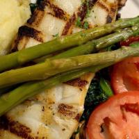 Chilean Sea Bass · Charbroiled sea bass served with mashed potatoes, on a bed of spinach  & mushrooms