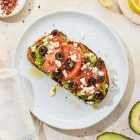 Greek Goddess Avocado Toast · Avocado toast with tomato, black olives, feta, and olive oil.