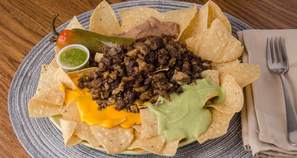 Nachos With Meat, Beans, Cheese & Guacamole · Crispy homemade chips with choice of meat, guacamole, nacho cheese, beans and our signature salsa on the side
