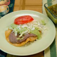 Tostada With Beans · Flat crunchy tostada with, beans, lettuce, guacamole, pico de gallo, cheese and salsa