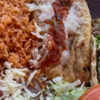 Chile Relleno · Two homemade Chile Rellenos with rice, beans, salad, guacamole, cheese, chips, cheese, sala