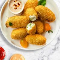 Jalapeño Poppers · (Vegetarian) Fresh jalapenos coated in cream cheese and fried until golden brown.