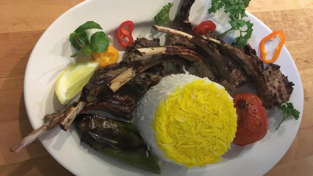 Lamb Chops · Marinated lamb chops grilled and served with BBQ tomato, pepper and basmati rice.