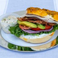 Savory Manwich · Chive cream cheese, turkey, bacon, lettuce, tomato, avocado & onion on your choice of bagel.