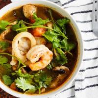 Tom Yum Seafood Bowl · Hot and sour soup with lemon grass, kaffir lime leaves, mushroom, green onion, and cilantro.