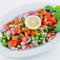 Shirazi Salad · Combination of fresh chopped Persian cucumbers, Roma tomatoes, red onions, olive oil, and fr...