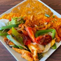 Fajitas · Choice of meat grilled with bell pepper, tomato, and onions. Sides of rice, refried beans, s...
