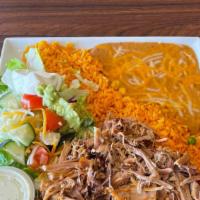 Traditional Pork Carnitas Plate · Grilled carnitas with sides of salad, rice, refried beans, sour cream, guacamole, and 3 tort...