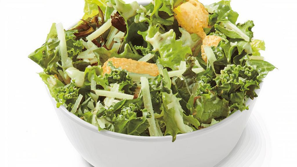 Caesar Side Salad · Tuscan greens and kale tossed in a Caesar dressing with garlic croutons and parmesan. | 210 Calories