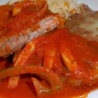 Steak Ranchero · 12oz NY steak topped with bell peppers and onions in a tomato salsa. Served with rice and be...