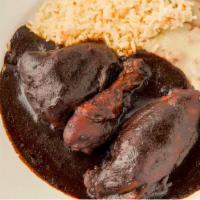 Chicken En Mole · Chicken smothered in a rich chocolate sauce with ingredients from all over Mexico. Served wi...