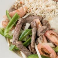 House Special Fajitas · Choice of beef or chicken, served with fresh sautéed onions and bell peppers. Garnished with...