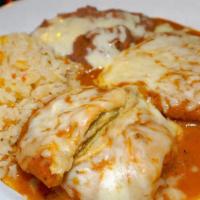 Chile Rellenos · Fried stuffed peppers. Contains eggs and cheese. Served with rice and refried beans