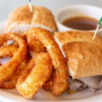 The Banker Hot Sandwich
 · Thin sliced roast beef piled high on a French roll and topped with grilled onions, Ortega ch...