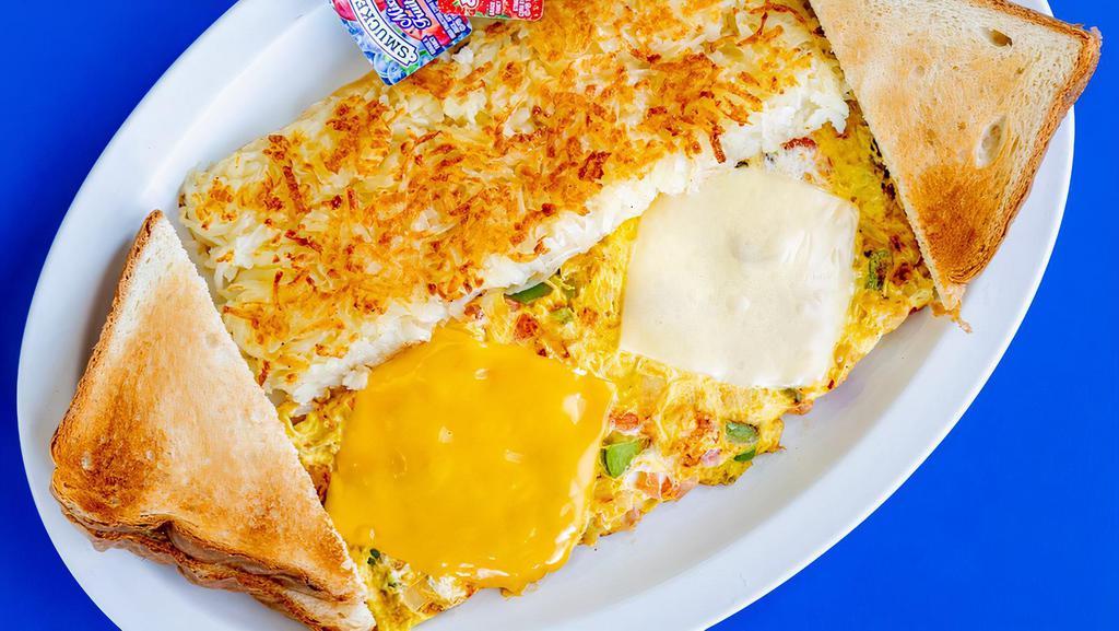 Vegetarian Omelette · Eggs, green and red bell peppers, onions, tomatoes, and melted American & Swiss cheeses. Served with fresh hash browns and toast.