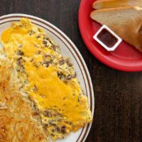 Carne Asada Omelette · Carne asada, eggs, and melted American & Swiss cheeses. Served with fresh hash browns and to...