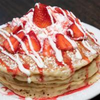 Strawberry Pancakes · 3 pancakes topped with fresh strawberries, sweet cheesecake cream, strawberry glaze,  whippe...