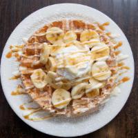 Banana Waffle · Belgian waffle topped with fresh bananas, sweet cheesecake cream, caramel syrup, whipped cre...