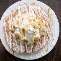 Banana Pancakes · 3 pancakes topped with fresh bananas, sweet cheesecake cream, caramel syrup, whipped cream, ...