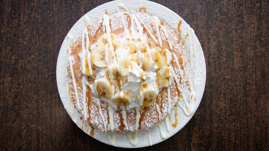 Banana Pancakes · 3 pancakes topped with fresh bananas, sweet cheesecake cream, caramel syrup, whipped cream, cinnamon, and powdered sugar.