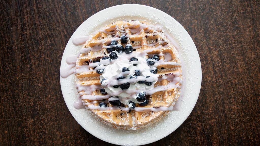 Blueberry Waffle · Belgian waffle topped with fresh blueberries, sweet cheesecake cream, Smucker's blueberry syrup,  whipped cream, cinnamon, and powdered sugar.