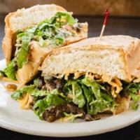 Torta · La torta bread filled with meat of choice, mayo, lettuce, tomatoes, refried beans, sour crea...