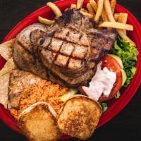 Pork Chops Dinner · 3 pork chops. Served with our fresh Mexican rice, refried beans, French fries, a small green...