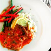 Salmon Pescatora · Grilled salmon fillet lightly seasoned covered in a seafood vodka sauce served with mashed p...