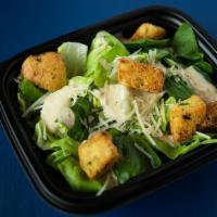 Side Caesar Salad · Heart of romaine, shaved parmesan, toasted crouton, creamy caesar dressing.