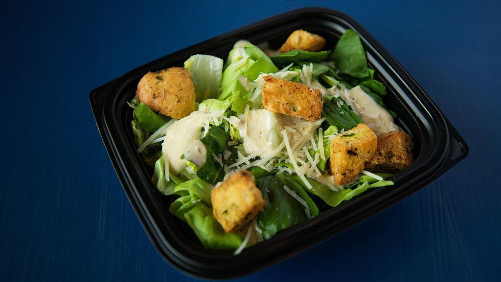 Side Caesar Salad · Heart of romaine, shaved parmesan, toasted crouton, creamy caesar dressing.