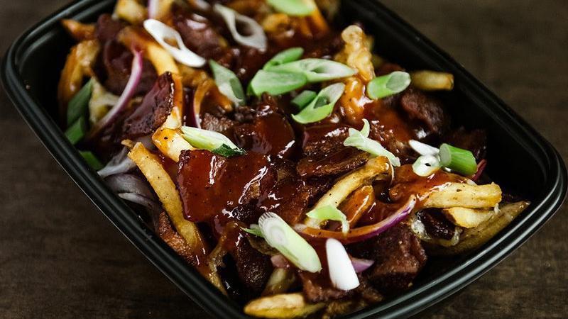 Burnt End Pork Belly Fries · Fries topped with smoked pork belly, burnt end-seasoning, shredded white American cheese, scallions, red onion, garlic oil, BBQ glaze