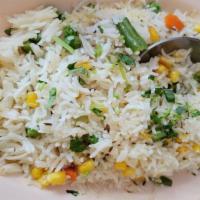 Pulao Rice · Basmati rice fried with herbs, spices, and green peas.