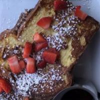 Brioche French Toast · Three thick slices dipped in our special egg batter, sprinkled with powdered sugar, and topp...