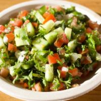 Shirazi Salad · Chopped parsley, diced tomato, cucumber, lemon juice and extra virgin olive oil.