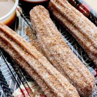 Churros · Our delicious Churros come with a caramel & chocolate dipping sauce 3pc