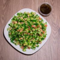 Iraqi Salad  · Cucumber, tomatoes, chickpeas, and parsley.