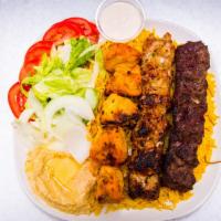 Our Famous Combo · 1 beef kabob, 1 chicken kabob, 1 chicken tikka skewer, served with yellow rice, salad, and h...